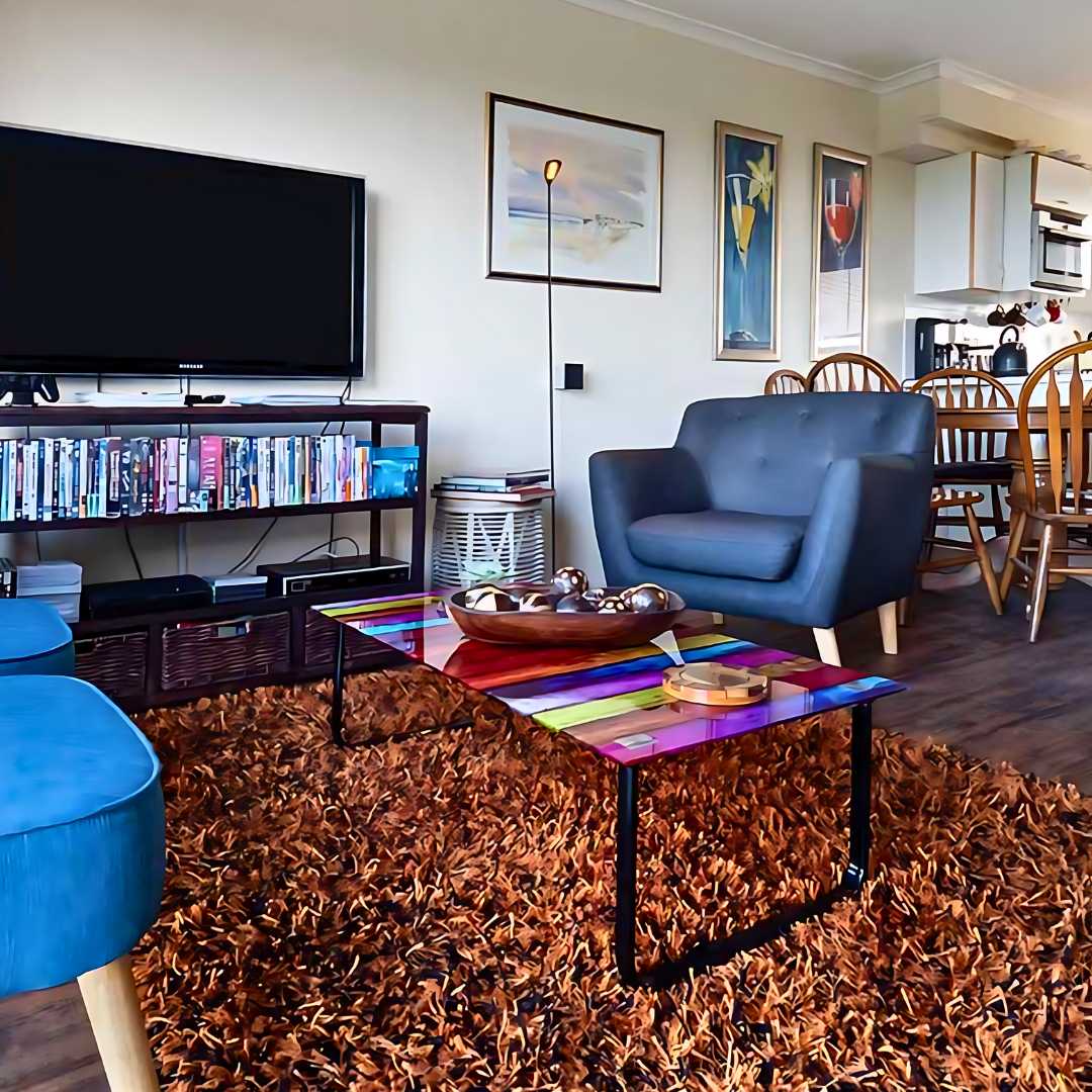 a small living room with dining tablle and tv