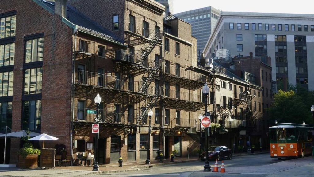 a city street with buildings and a tram