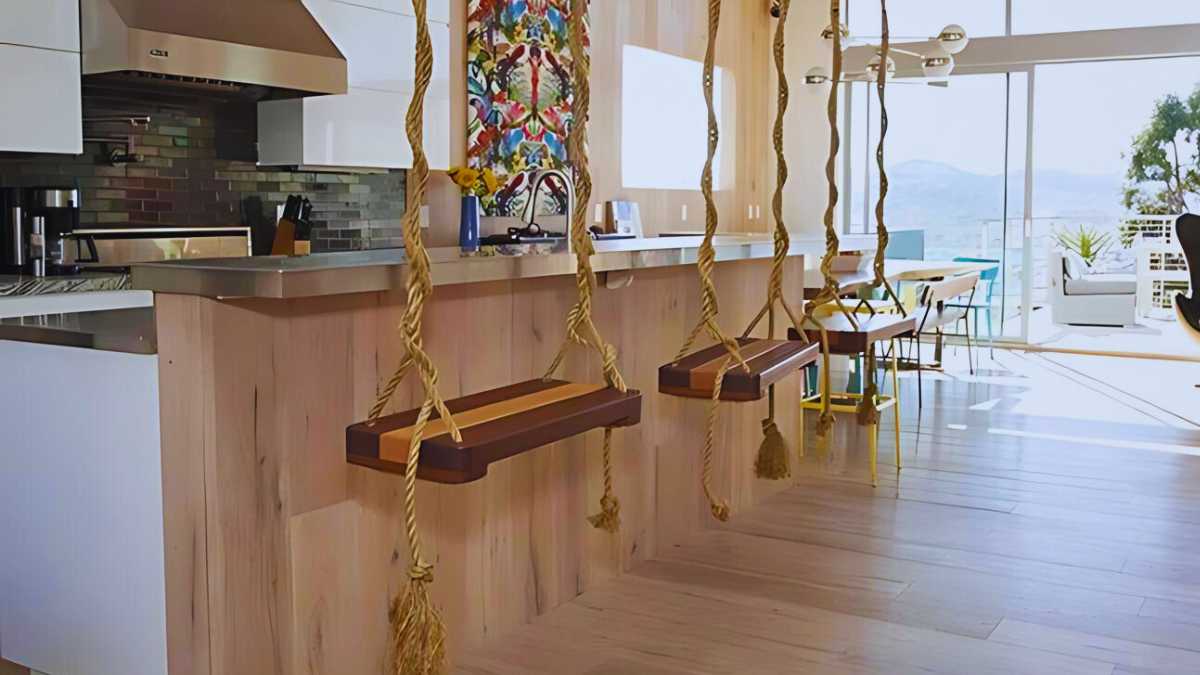 a kitchen island with swings as seating