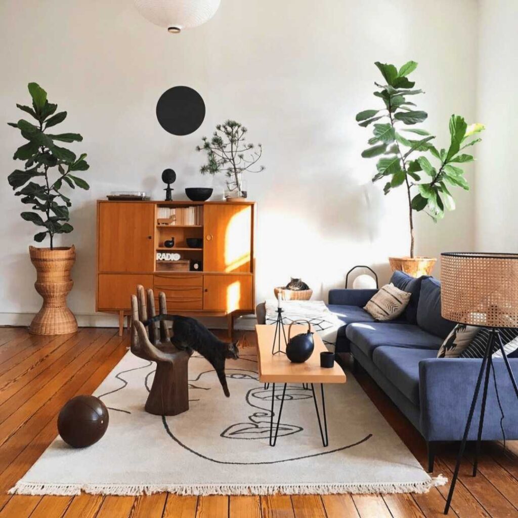 art and plants in small living room