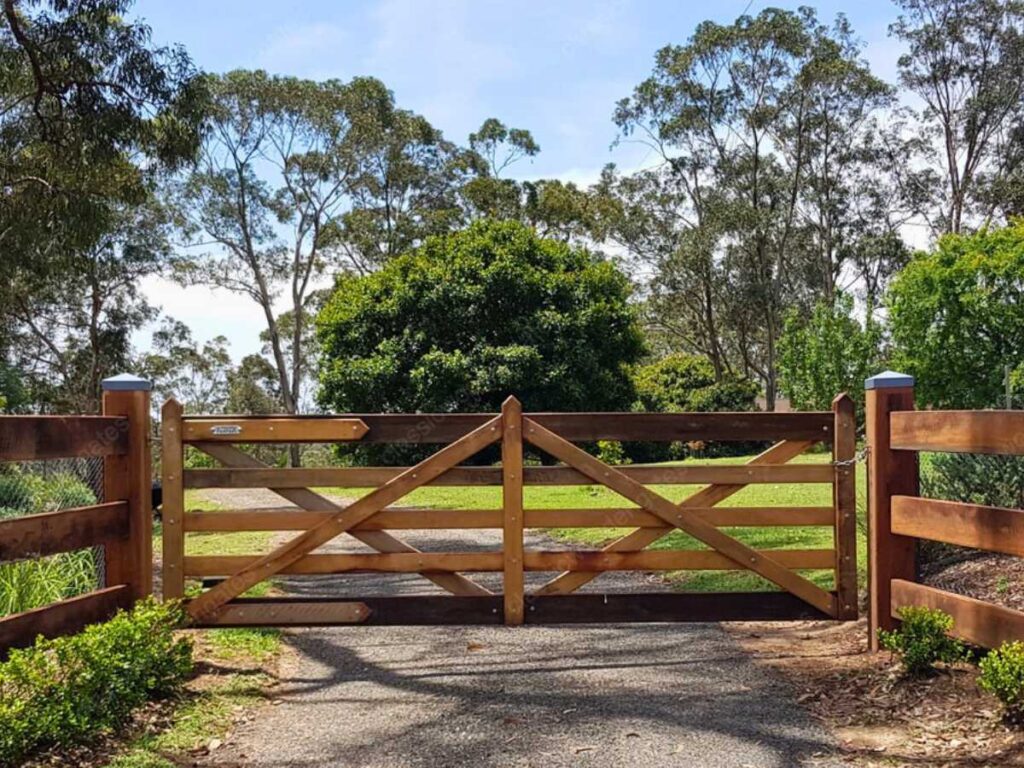 a farmhouse split rail wooden driveway gate