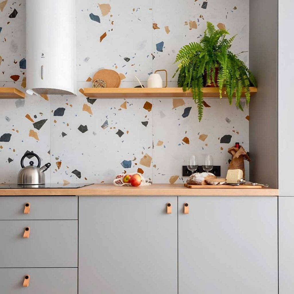 a kitchen with a modern terrazzo backsplash