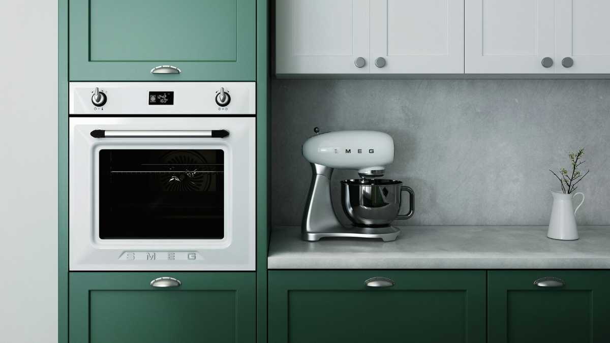 a retro white ceramic saucer on a white and green wooden cabinet in the kitchen