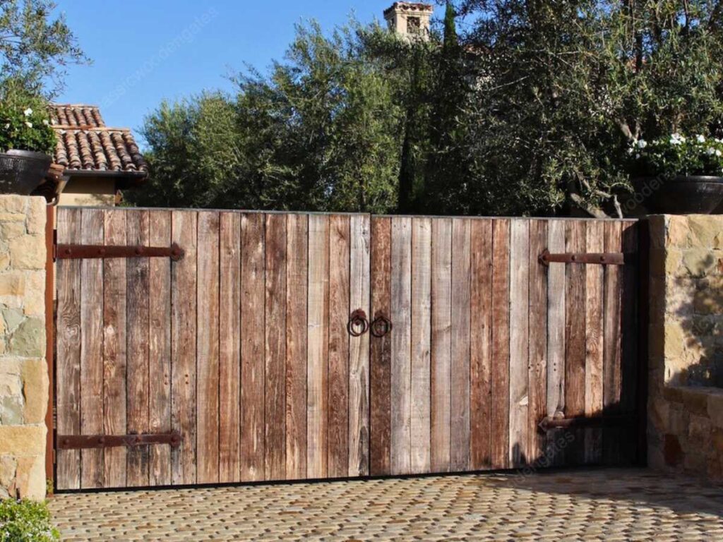 a rustic barn sttyle wooden driveway gate