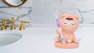 a cute kid in pig dress toothbrush holder