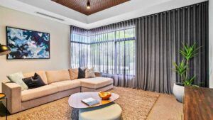 a living room with sheer curtain and drape