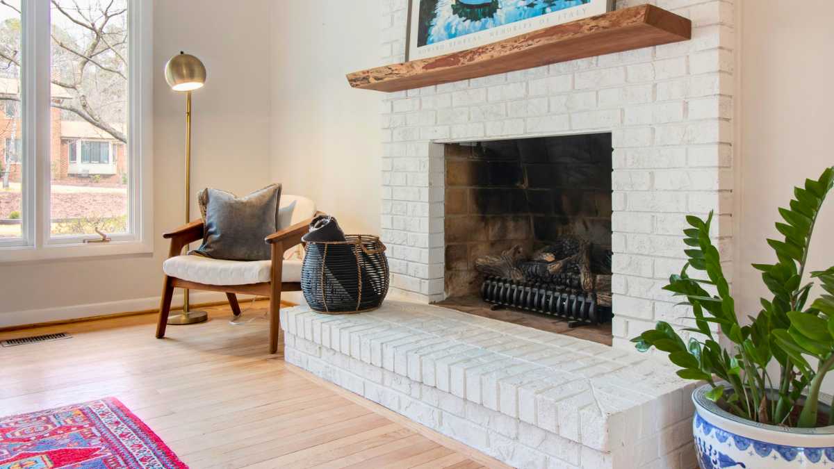 a room with white brick fireplace