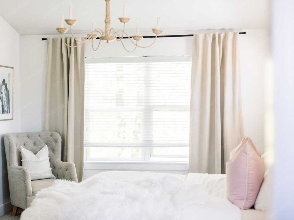 bedroom with layered window treatment